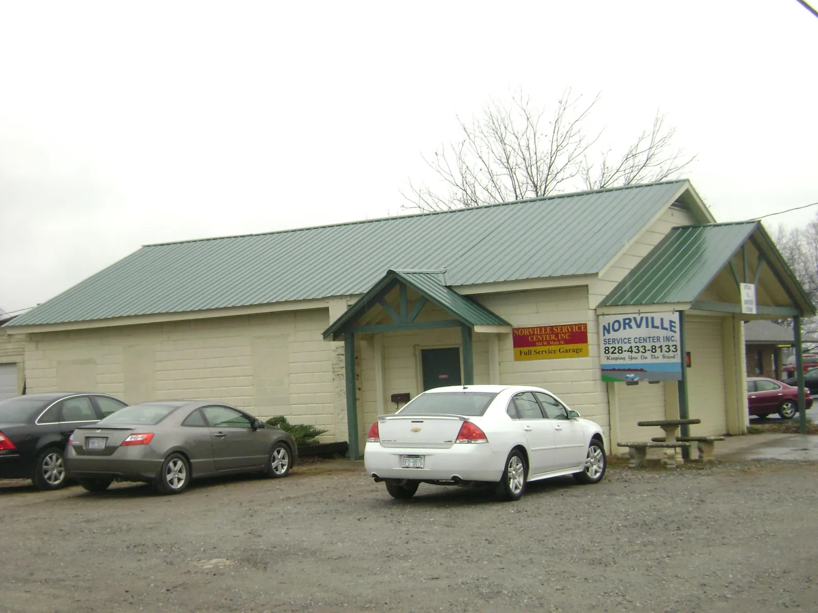 Green metal roof on a service garage with a covered entry in Monroe